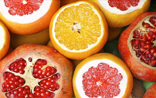 sliced oranges, pomegranates, and grapefruits
